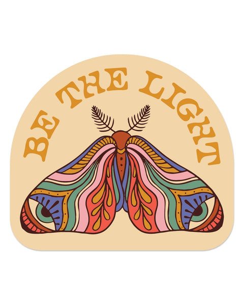 Be The Light Sticker in cream with an arched top, showing a retro rainbow-striped moth under orange lettering, on white.