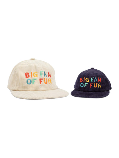 Matching adult and kids 'Big Fan Of Fun' hats in beige and navy for family adventures. Perfect twinsie set for fun-loving duos. By Trek Light.