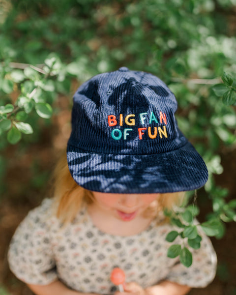 Big Fan Of Fun Kids Hat worn by a child, showcasing colorful embroidery and outdoor playfulness.