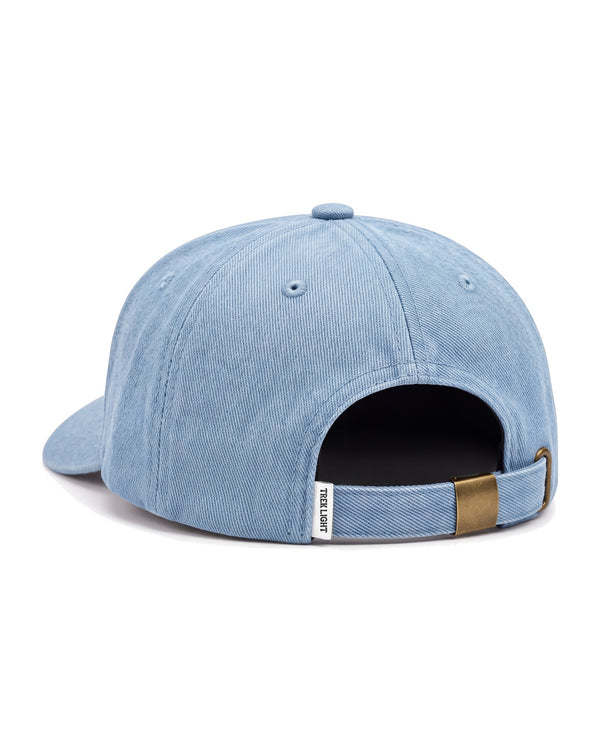 Back view of the Book Worm Kids Hat, a light blue washed denim cap with a metal buckle strap, on white.