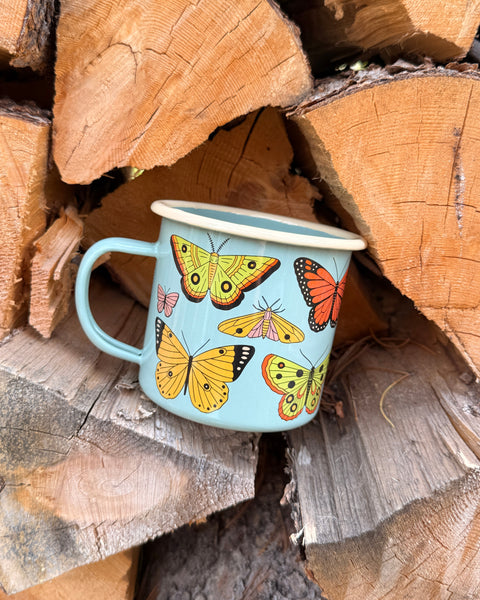 Butterfly Beauty Mug - Enamel 16oz Mug featuring colorful butterflies against a rustic wood backdrop.
