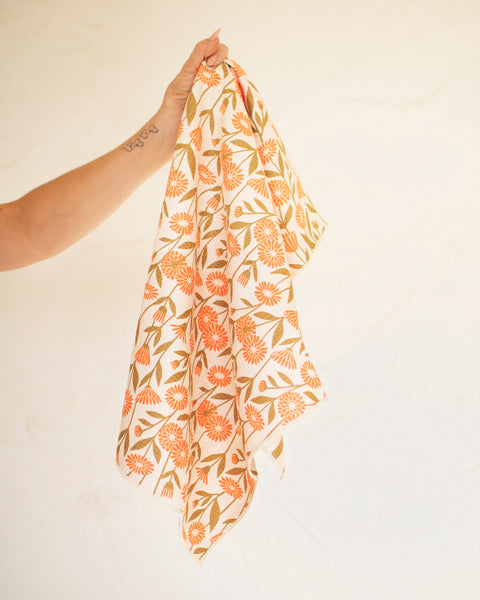 Image of Calendula Flowers Kitchen & Tea Towel, featuring bright floral design and held up for display.