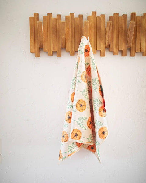 California Kitchen & Tea Towel hanging on a wall, featuring vibrant floral design, perfect for adding style to kitchens.