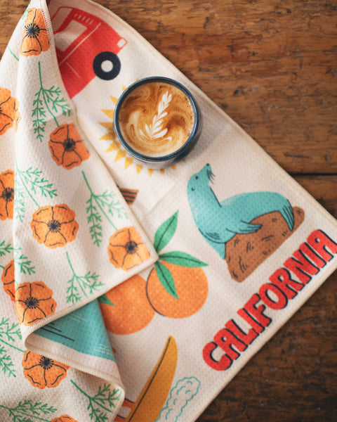 California Kitchen & Tea Towel with vibrant designs of California's nature and a latte on a rustic table.
