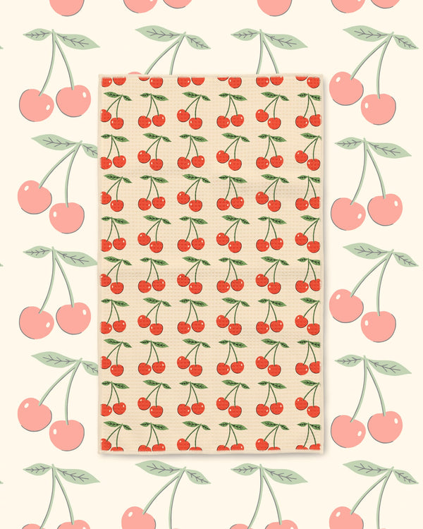 Cherry Lover Kitchen & Tea Towel with red cherries and green leaves in rows on a cream background
