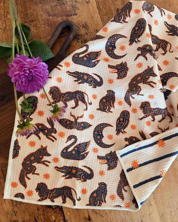 Cosmic Creatures Kitchen & Tea Towel featuring vibrant animal designs on eco-friendly fabric.