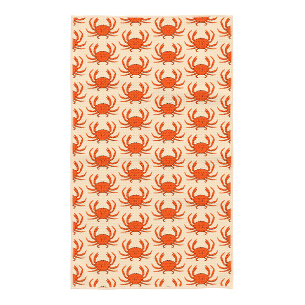 Kitchen tea towel with orange crab pattern on cream waffle-weave fabric, large crabs scattered across the towel with a