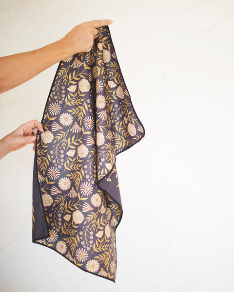 Dinner Music Kitchen & Tea Towel featuring floral design, held in hand, perfect for kitchen decor.