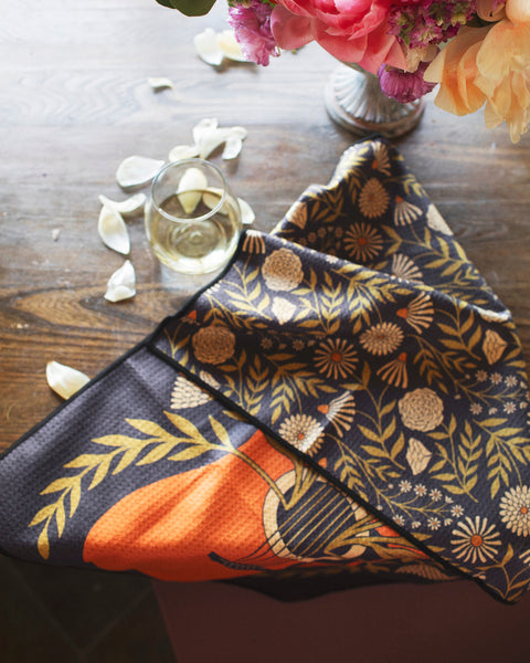 Dinner Music Kitchen & Tea Towel featuring floral design and guitar motif on a wooden table with flowers.