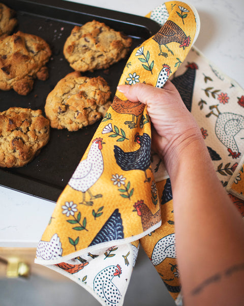 Farmhouse Chicken Kitchen & Tea Towel being used to grab cookies from a baking tray, featuring colorful chicken designs.