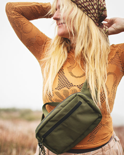 Everyday Fanny Pack (Fern) worn by a woman in a stylish outfit outdoors, showcasing its functional design.
