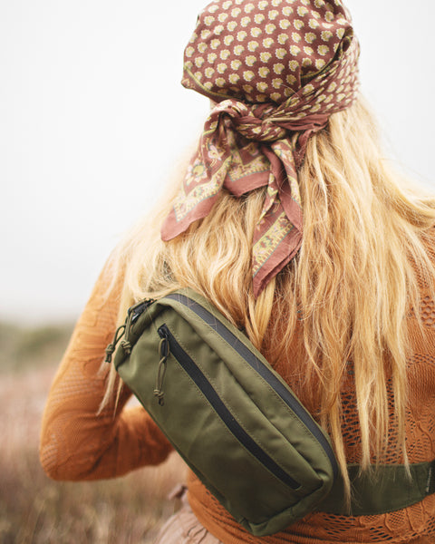 Person wearing Everyday Fanny Pack (Fern) crossbody in a outdoor setting, showcasing versatility and style.