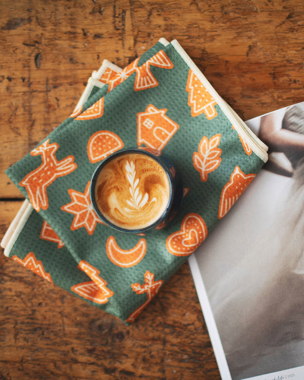 Gingerbread Kitchen & Tea Towel on a wooden table with coffee and a magazine
