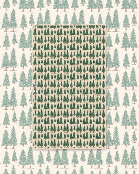 Gondola Winter tea towel laid over a matching cream ski resort pattern of mountains, gondolas, and pines