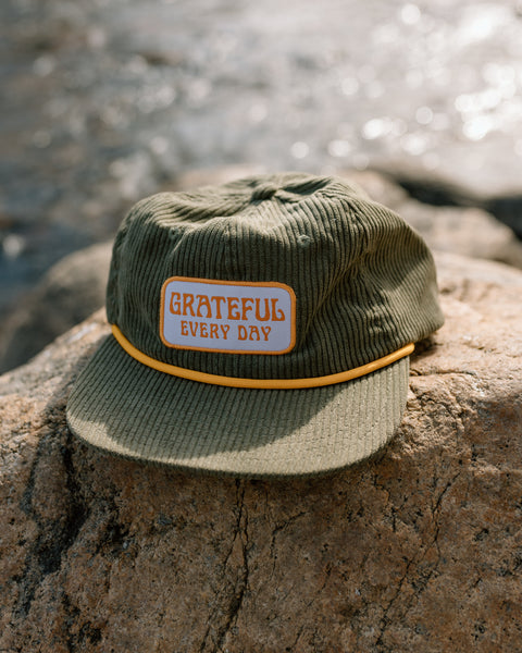Grateful Every Day hat by Trek Light, flat brim snapback in cotton corduroy, stylish unisex accessory for daily gratitude expression.