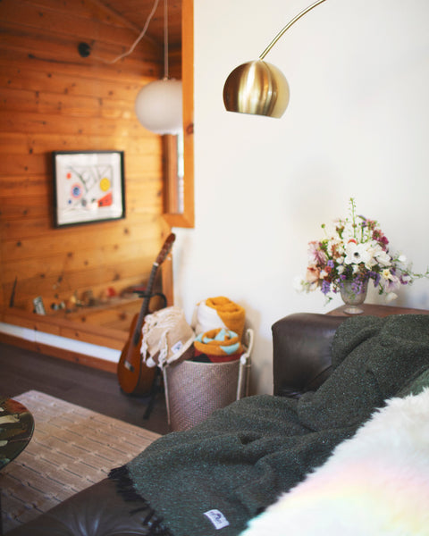 Stylish living room featuring the Greyson Blanket draped over a couch with decorative elements.
