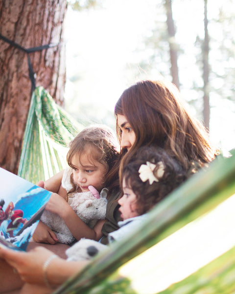 Woman and two children reading together in a Double Hammock & Pro Hanging Straps (River Trout Print).