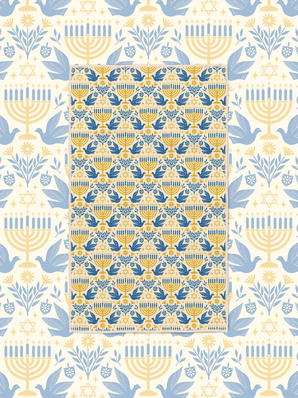 Gold and blue menorah, dove, and Star of David tea towel on cream Hanukkah-themed backdrop