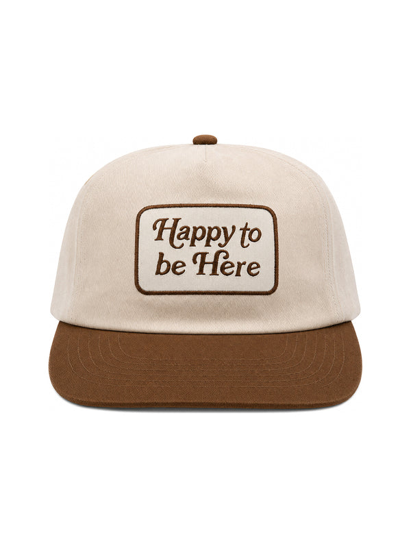 Happy To Be Here Hat featuring beige fabric with brown visor and embroidered lettering.