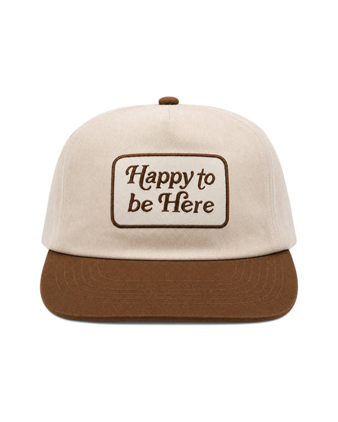 Happy To Be Here Hat featuring beige fabric with brown visor and embroidered lettering.