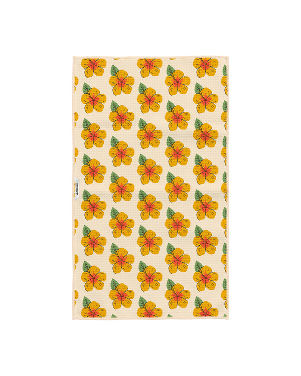 Reverse side of the Hawaii kitchen tea towel with a repeating yellow and orange hibiscus flower pattern on cream Grip-Tex