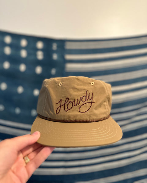 Howdy Hat in hand, showcasing the embroidered design, perfect for festivals and road trips.