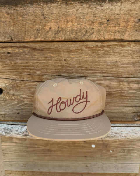 Howdy Hat displayed on a rustic wooden background, showcasing its 5-panel design and adjustable fit.