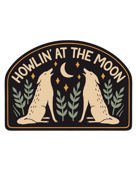 Howlin' At The Moon Sticker with two tan coyotes howling at a crescent moon, green leaves, orange stars, black arch, on white