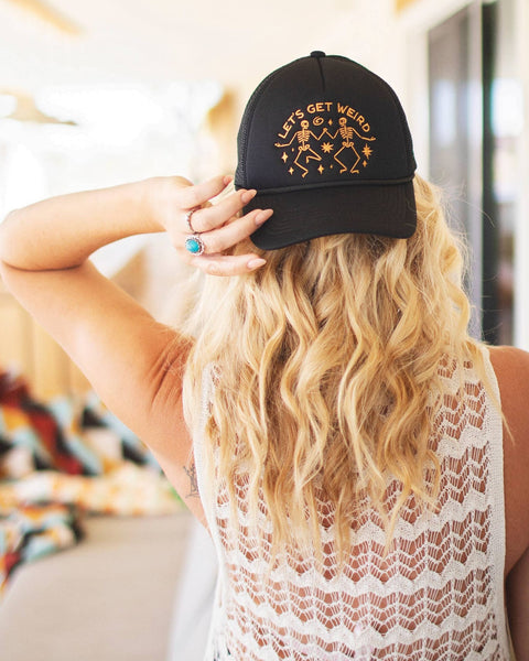 Back view of a person wearing the Let's Get Weird Hat, showcasing its unique design and laid-back style.