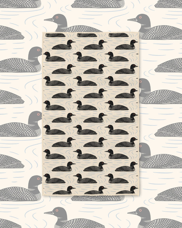 Loons Kitchen & Tea Towel with black loons swimming in rows on a cream background