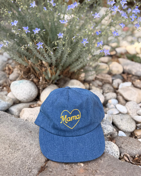 Mama Hat displayed on stones with flowers, showcasing its stylish and comfortable design.