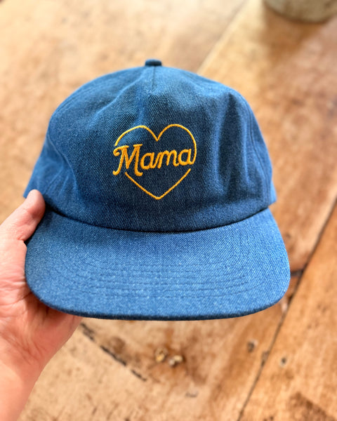 Hand holding a denim Mama Hat with a heart design, perfect gift for moms, showcasing pride in motherhood.
