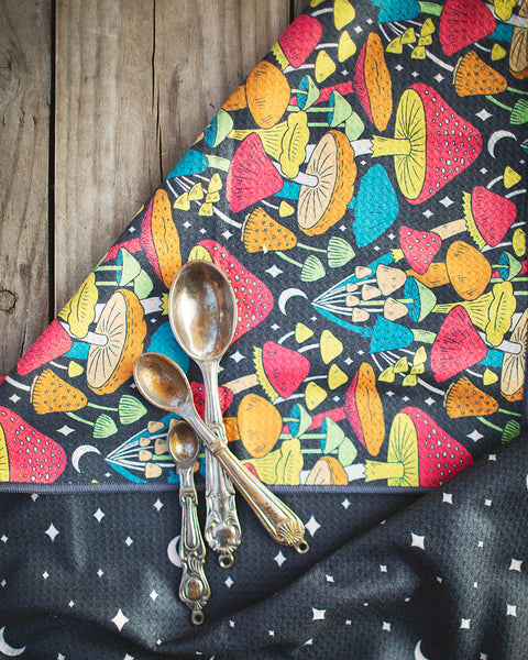 Colorful Midnight Mushroom Kitchen & Tea Towel with vintage spoons on wooden surface.