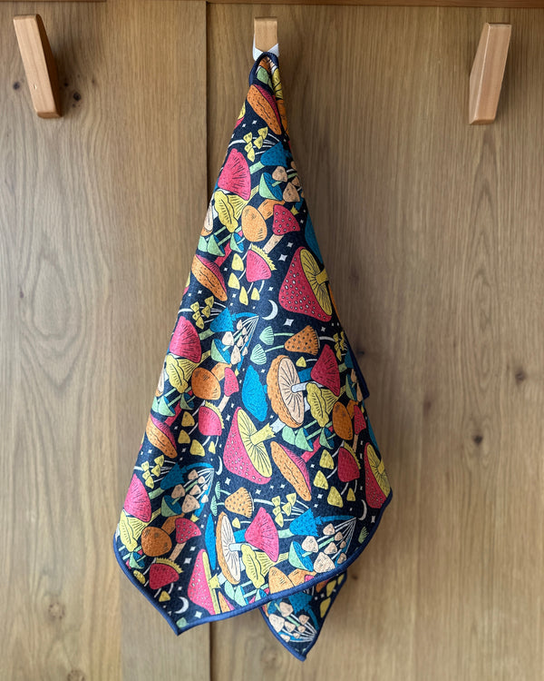 Midnight Mushroom Kitchen & Tea Towel hanging, showcasing vibrant double-sided design with eco-friendly, super absorbent Grip-Texβ’ fabric.