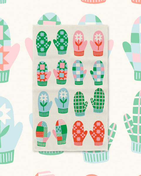 Mittens Kitchen & Tea Towel with red, green, pink and blue patterned mittens on a cream background