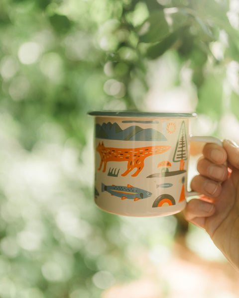 Mountain Stream Enamel Mug 16oz featuring a colorful outdoor design with nature elements.