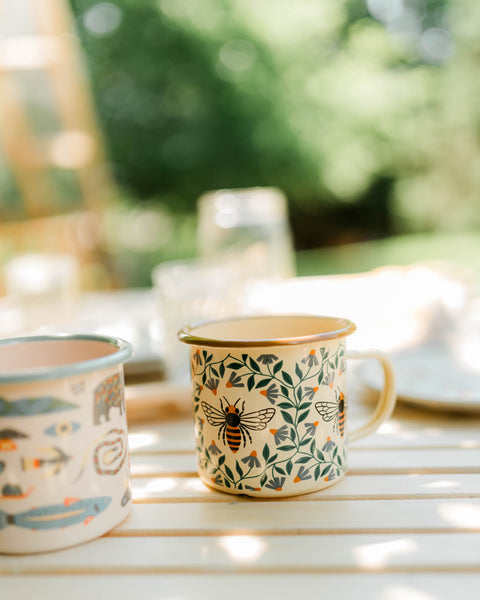 Honey Bee Enamel Mug 16oz featuring a vintage design with bees and leaves, perfect for cozy mornings and camping.