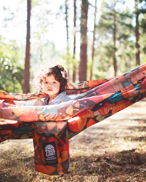 Double Hammock & Pro Hanging Straps (Midnight Mushroom Print) with child in natural setting.