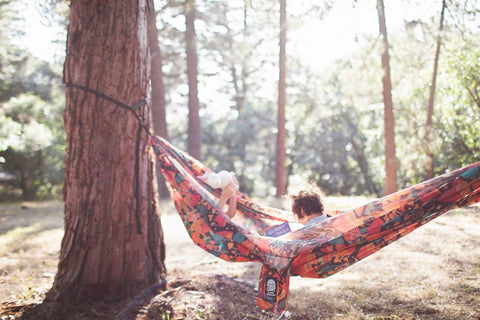 Double Hammock & Pro Hanging Straps (Midnight Mushroom Print) in use with children in a forest setting.
