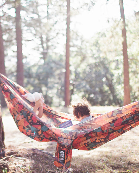 Double Hammock & Pro Hanging Straps (Midnight Mushroom Print) in use with children in a forest setting.