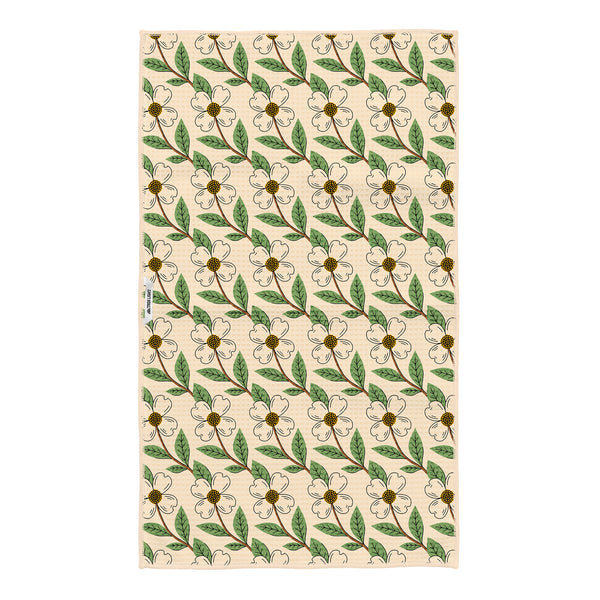 North Carolina tea towel with repeating pattern of white dogwood flowers and green leaves throughout