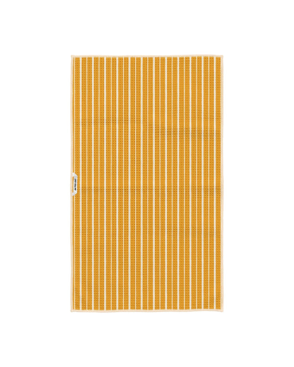 Reverse side of Pasta Time tea towel showing golden yellow and cream vertical stripes with Trek Light tag