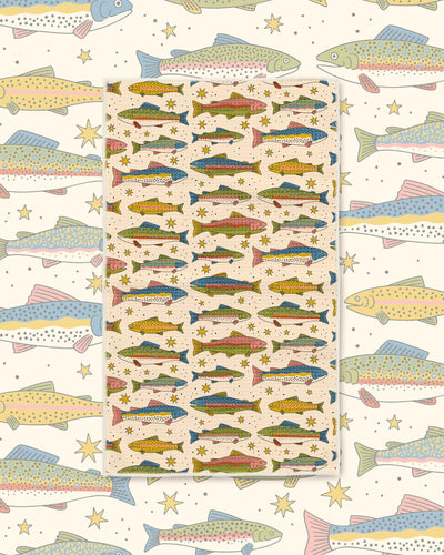 River Trout Kitchen & Tea Towel with rows of colorful trout in green, blue and gold on a cream background