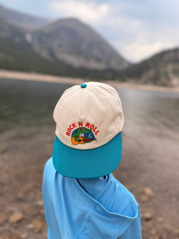 Rock N Roll Kids Hat displayed on a child's head near a lake, perfect for sunny adventures.