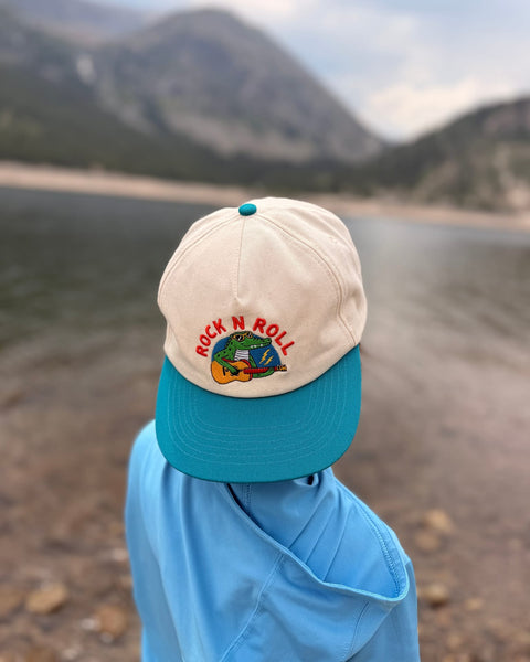 Rock N Roll Kids Hat displayed on a child's head near a lake, perfect for sunny adventures.