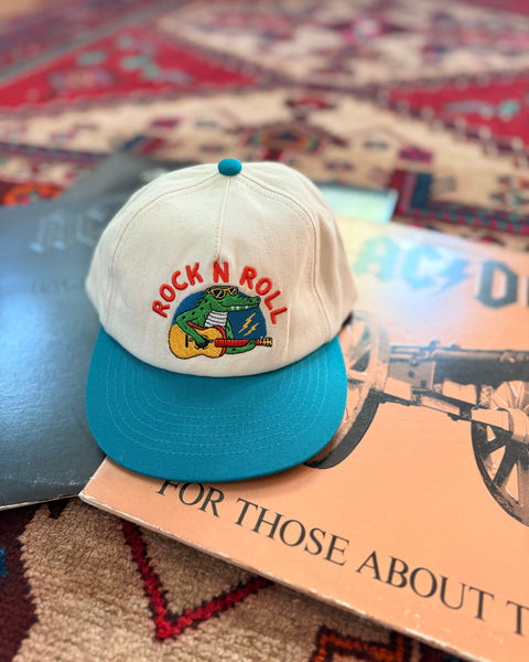 Rock N Roll Kids Hat displayed on a colorful rug with vinyl records, perfect for stylish adventures.