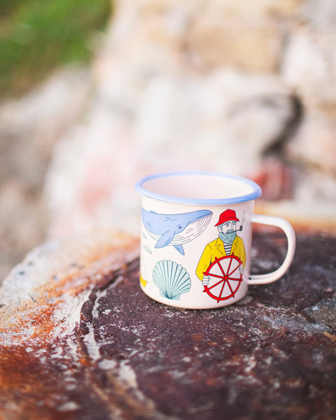 Salty Seas Enamel Mug 16oz featuring nautical design with sailor, whale, and shell motifs.