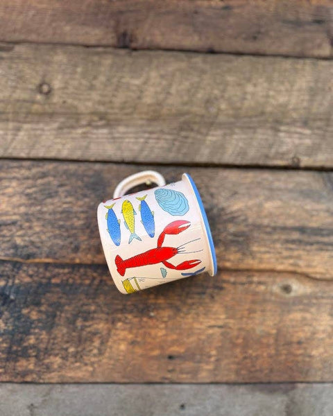 Salty Seas Enamel Mug 16oz showcasing a nautical design with fish and lobster on an enamel surface.