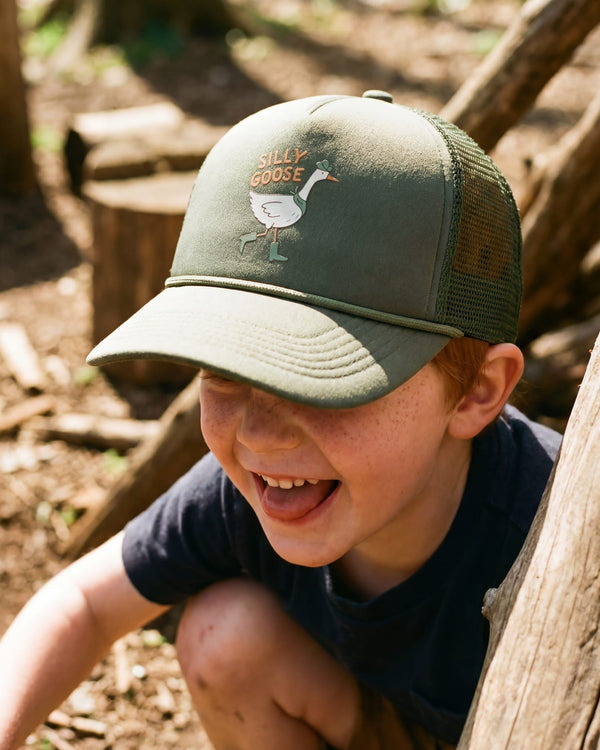 Child wearing a Silly Goose Kids Hat while playing outdoors, smiling and enjoying a sunny day.