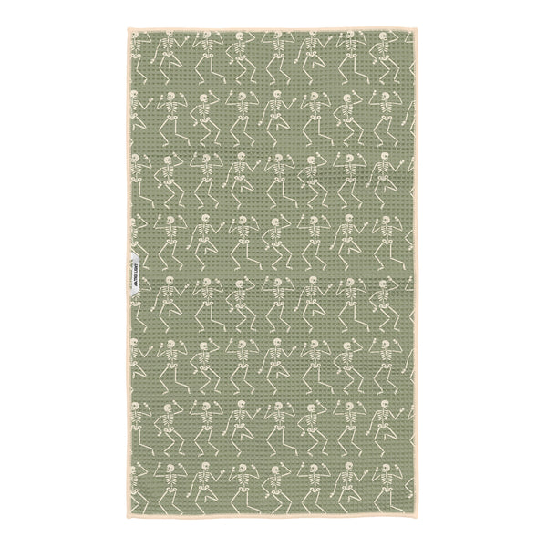Sage green kitchen tea towel with cream dancing skeleton pattern and hanging loop